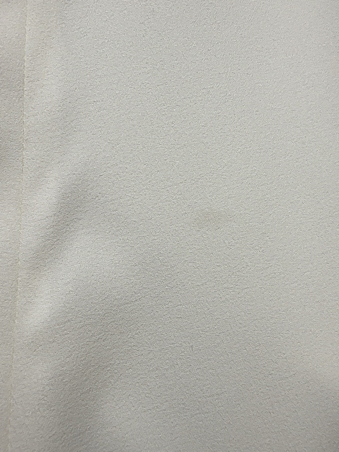 B3 ivory dress fabric close-up showing the tiny front mark