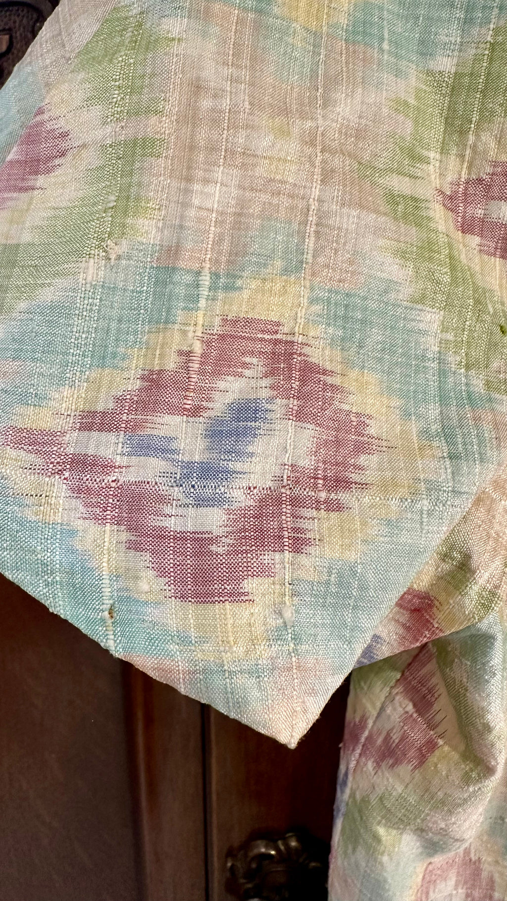 B51 fabric close-up showing pulls and loose threads near sleeve edge