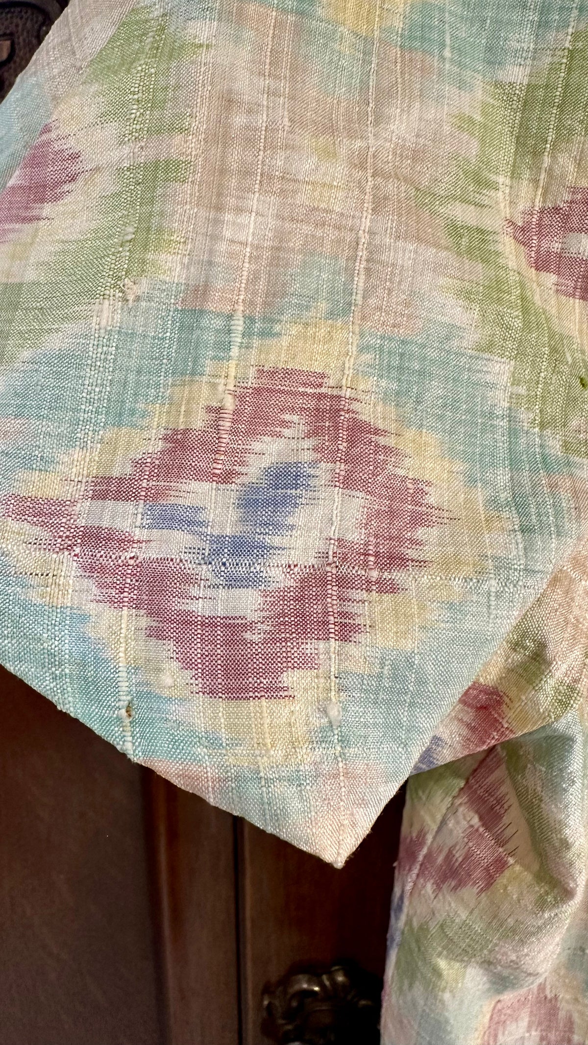 B51 fabric close-up showing pulls and loose threads near sleeve edge