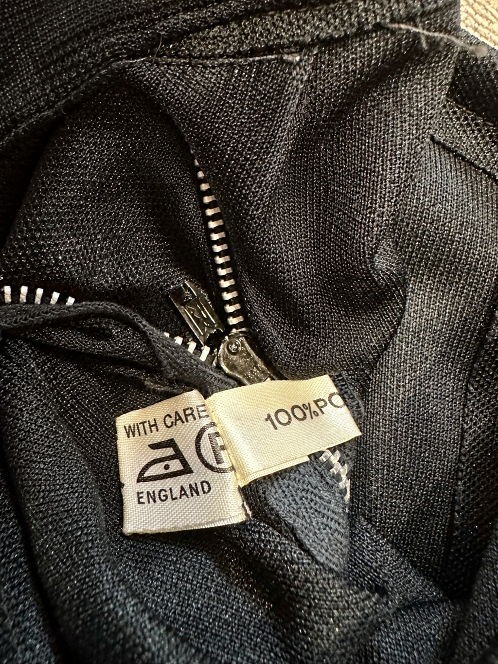 B56 care and made in England label — fingers removed